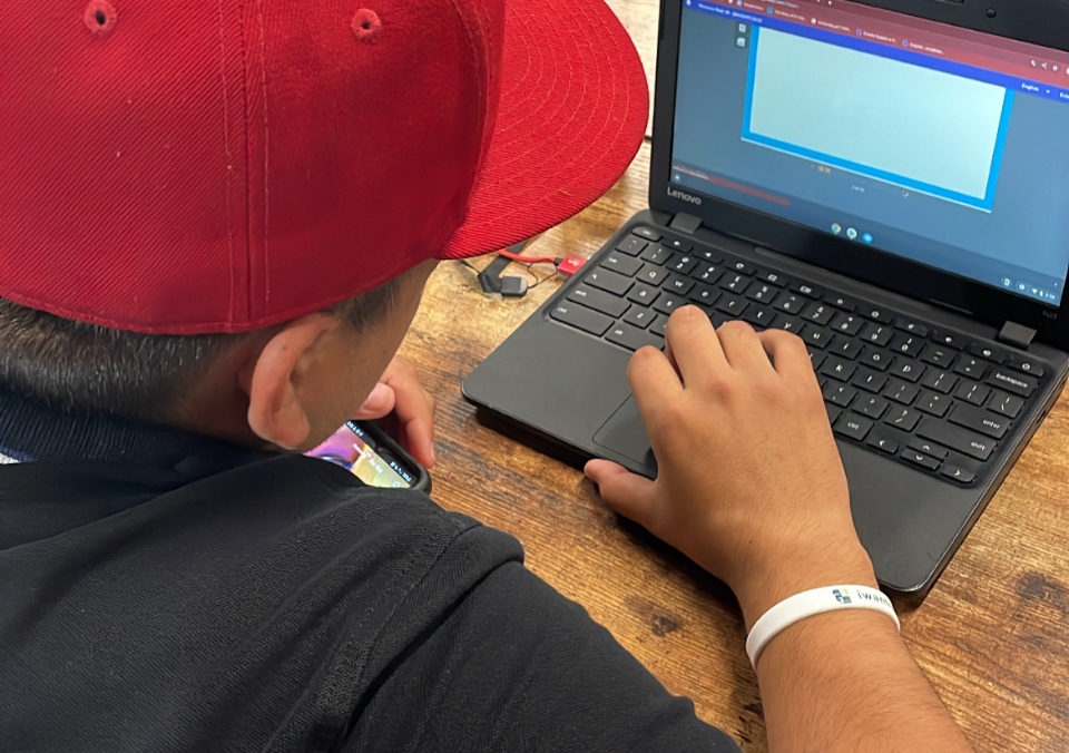 Student using personalized resources on a laptop while working on his class