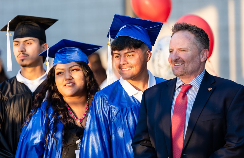 Graduates taking a photo with Pima County School Superintendent Dustin Williams