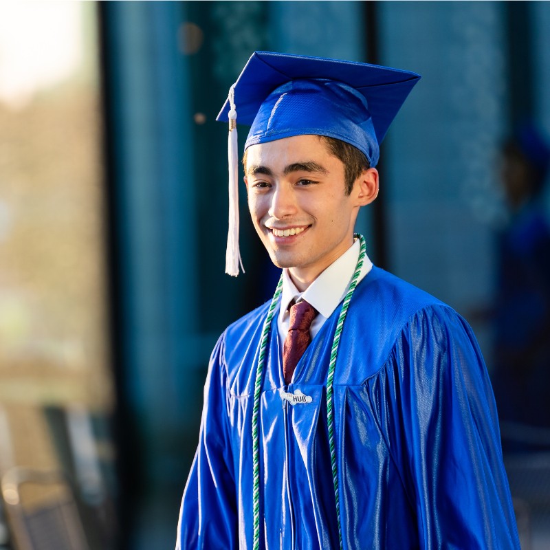 Graduate walking to their ceremony in cap and gown