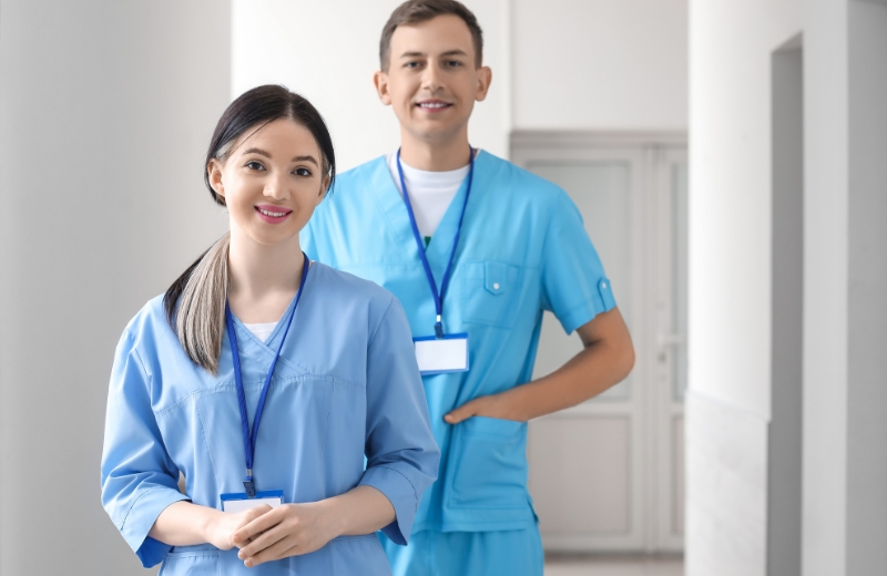 Students dressed in scrubs at a hospital