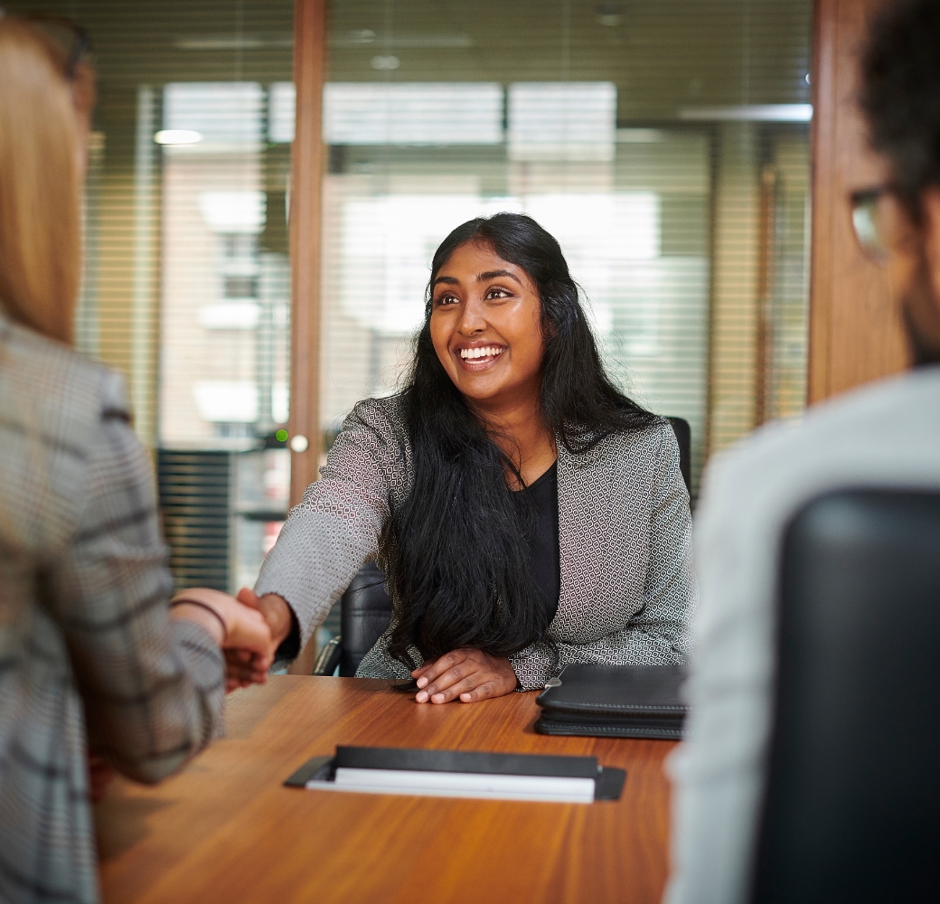 A graduate sitting down for a job interview