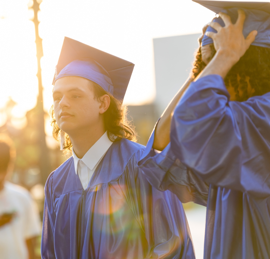 Students standing outside, preparing for their graduation ceremony