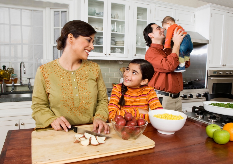 Family gathering in the kitchen to prepare a meal