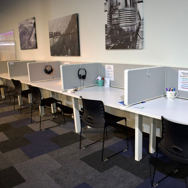 A wall of individual work stations set up at the Mesa HUB