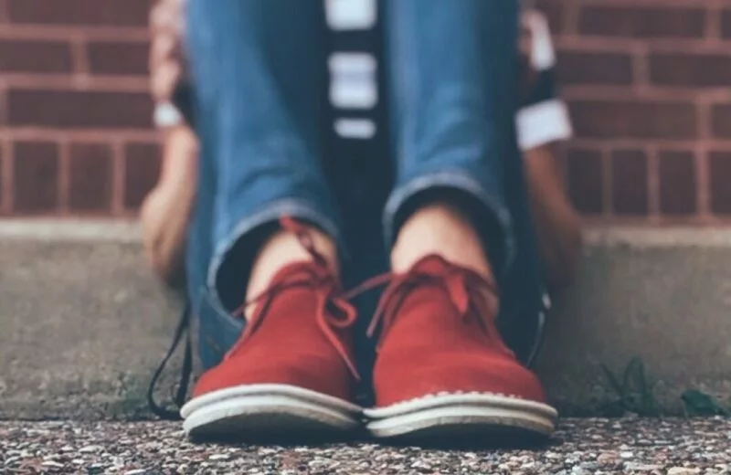 Student sitting alone outside