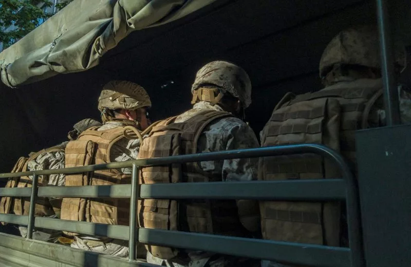 Soldiers sitting in the back of a transport