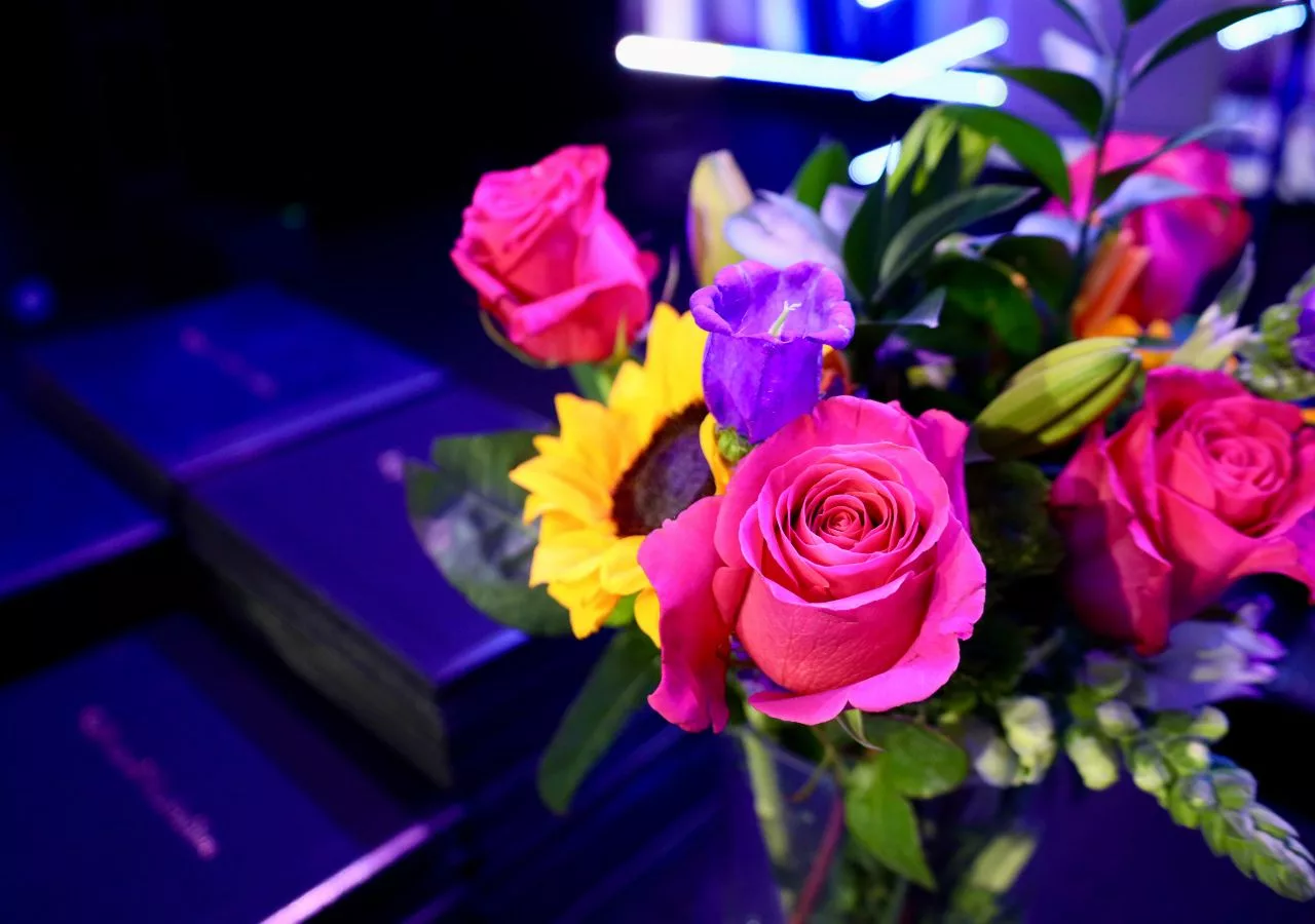 Pink and purple roses in a vase, on a table