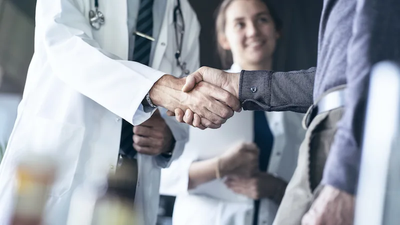 medical professionals shaking hands