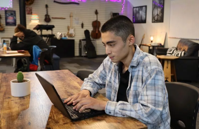 Student working on his coursework at the Mesa HUB