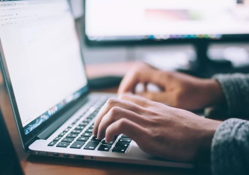 Close up photo of student's hands typing on their keyboard