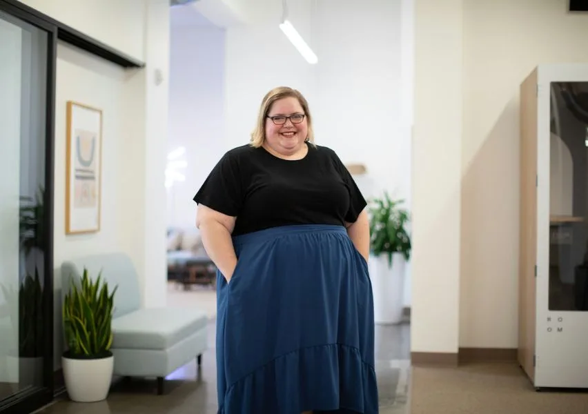 Young professional smiling at an office