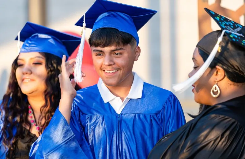 Graduate smiles as he prepares to walk into his graduation ceremony