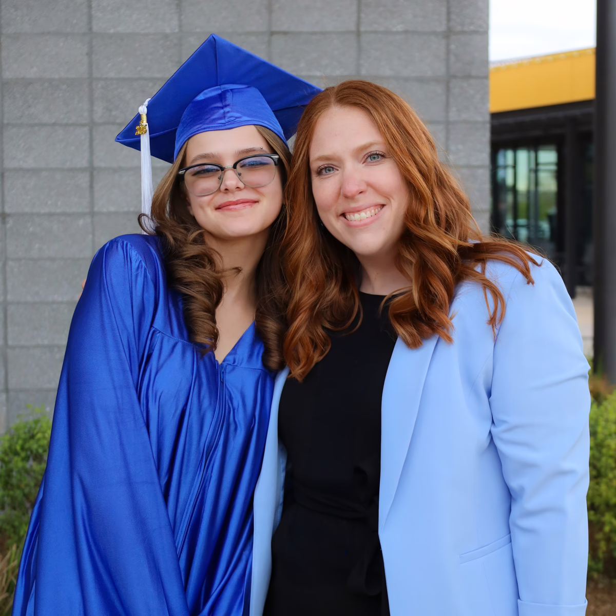 A student and their mentor smile next to each other