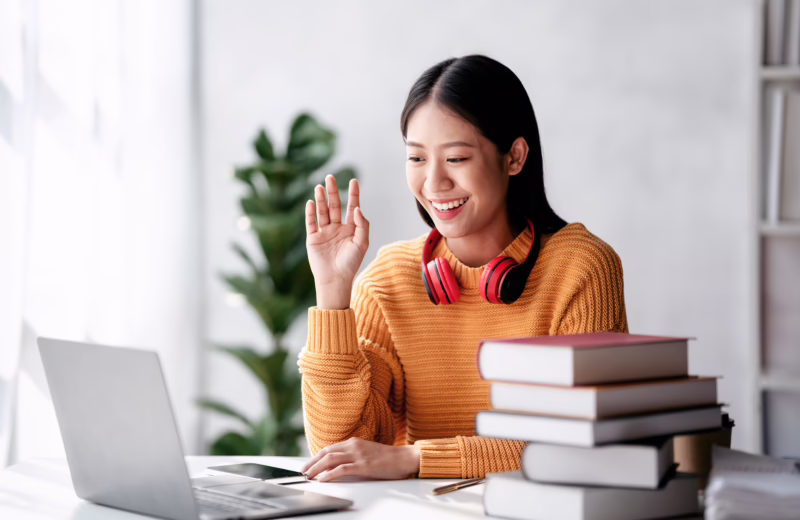 Distance education learning concept, Young woman in sweater studying education lesson online and greeting